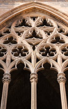 Detailed view of ornate gothic architecture in Lleida Cathedral, showcasing intricate stone carvings and arches.
