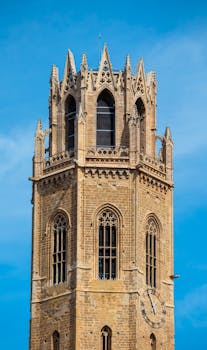 Beautiful Gothic bell tower against a clear blue sky in Lleida, Spain.