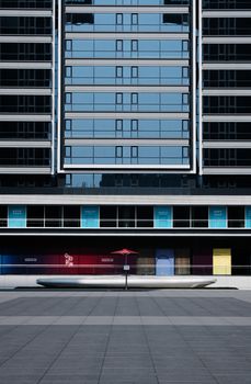 Front view of a modern urban building featuring geometric architecture and vibrant colors.