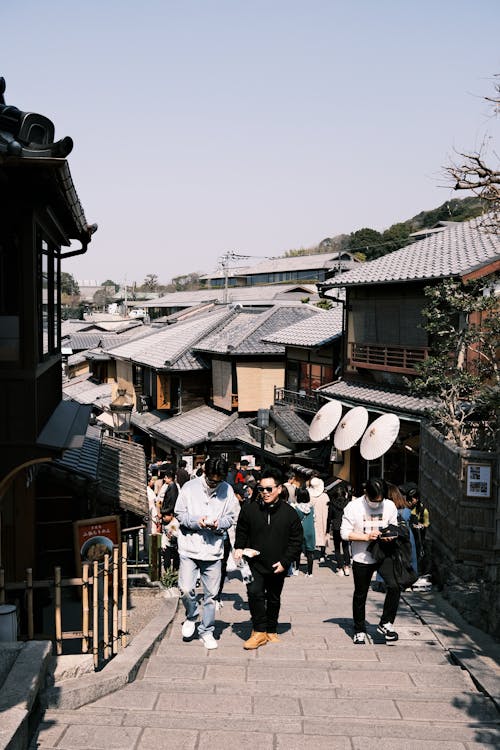 People walking down a narrow street in a japanese town