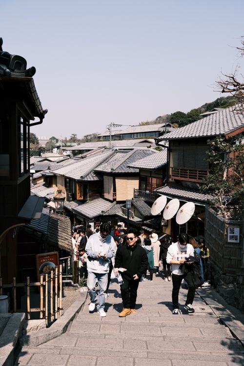 Free View of a busy traditional street in Kyoto with people exploring the historic area. Stock Photo