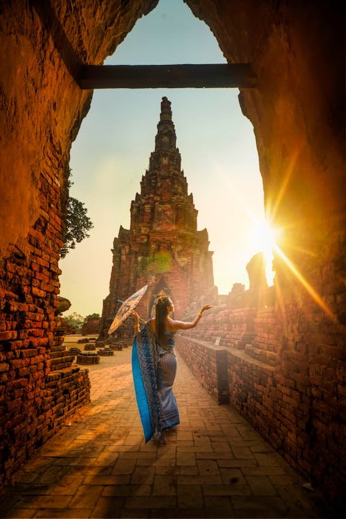 Free Woman Wearing Blue Dress With Umbrella during Sunset Stock Photo