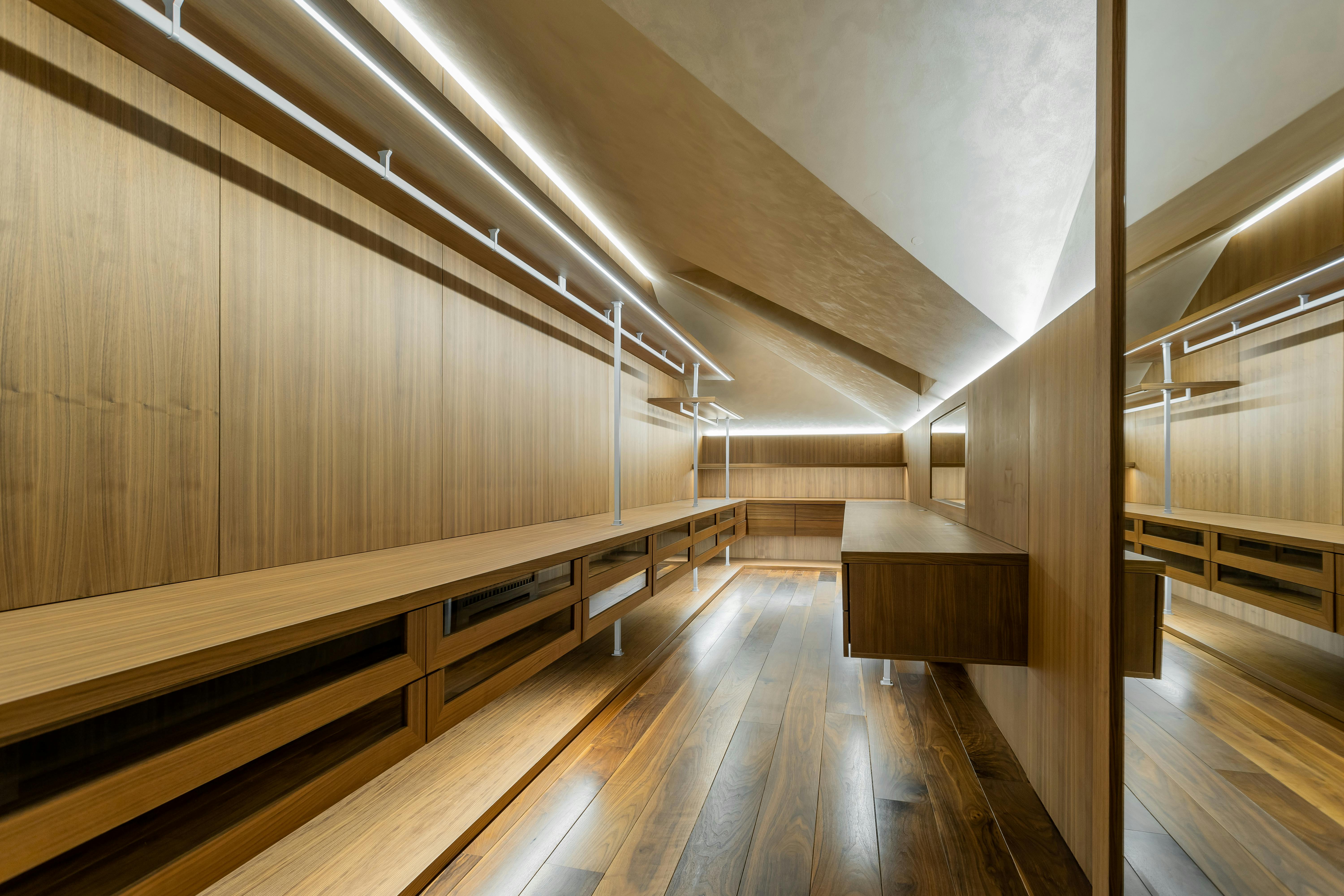 Professional lighting design in luxury walk-in closet showing multiple light sources
