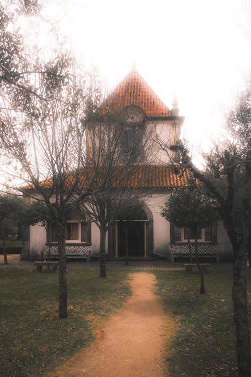 A church with a red roof and a path leading to it