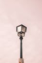 A street lamp with a pink sky background