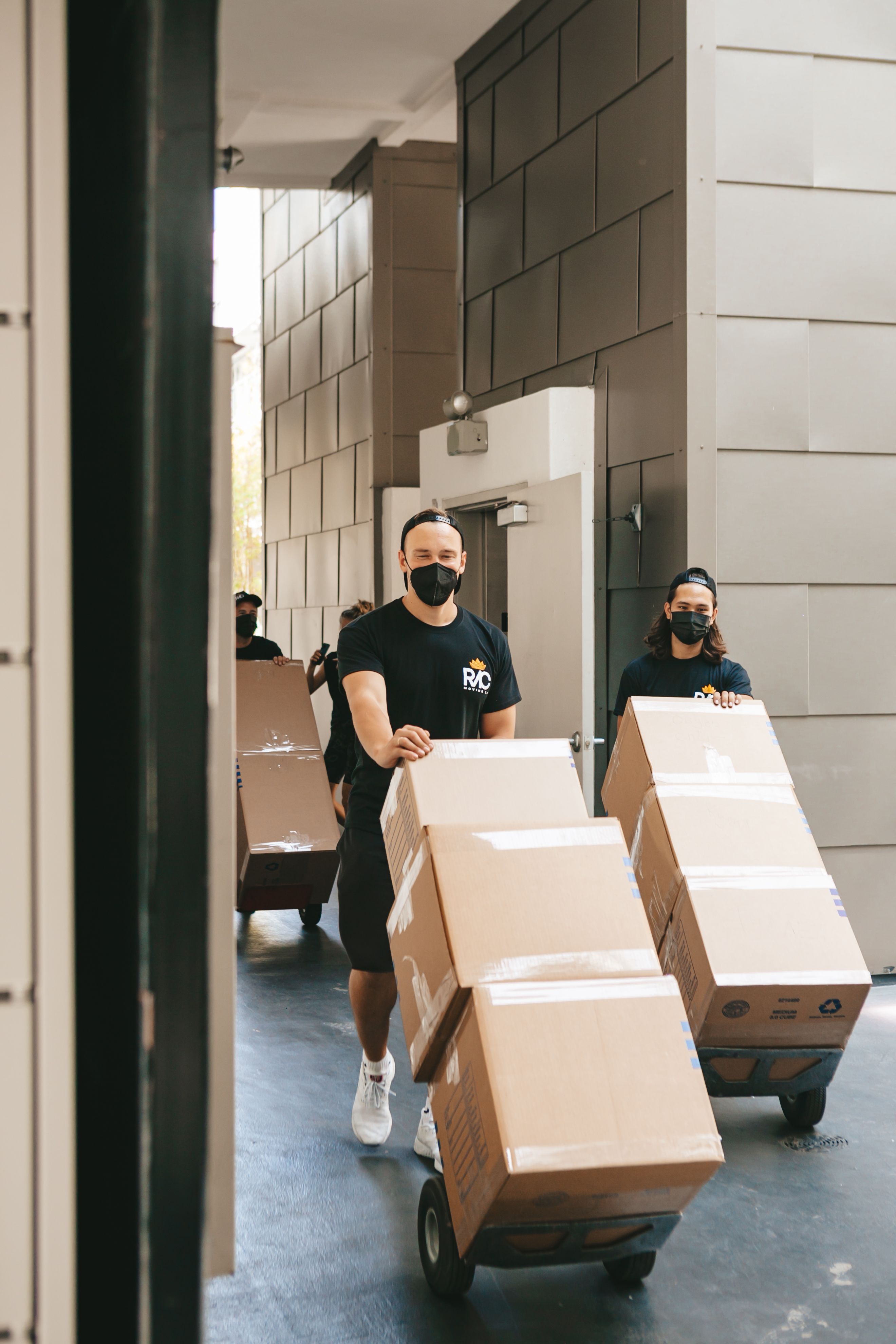 Men Walking with Boxes · Free Stock Photo