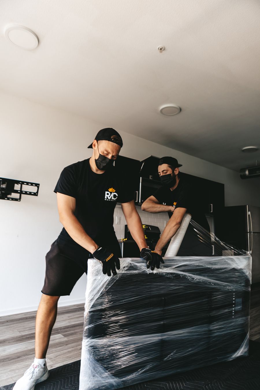 Crew wrapping furniture for protection