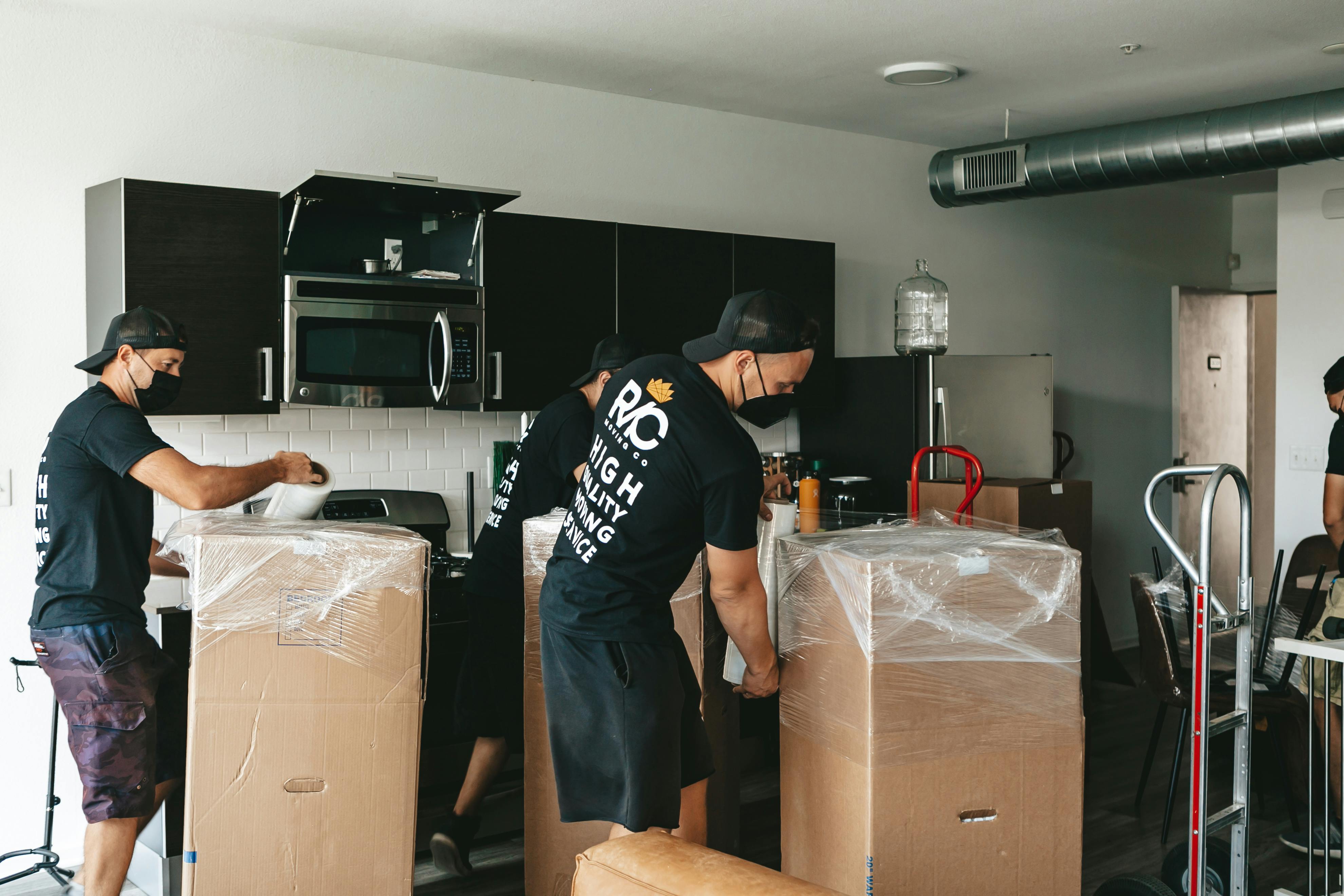 Men with Boxes in Kitchen by Royal Moving & Storage