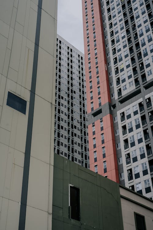 A tall building with windows and a red and white building