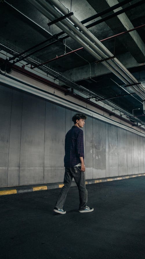 A man walking in an empty parking garage