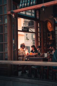 Warm interior of a vintage café with adults enjoying a casual dining experience.