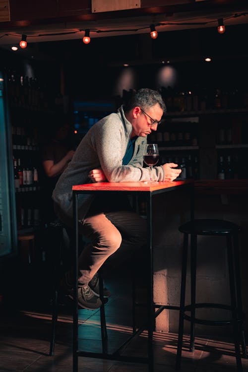 A man sitting at a bar with his phone