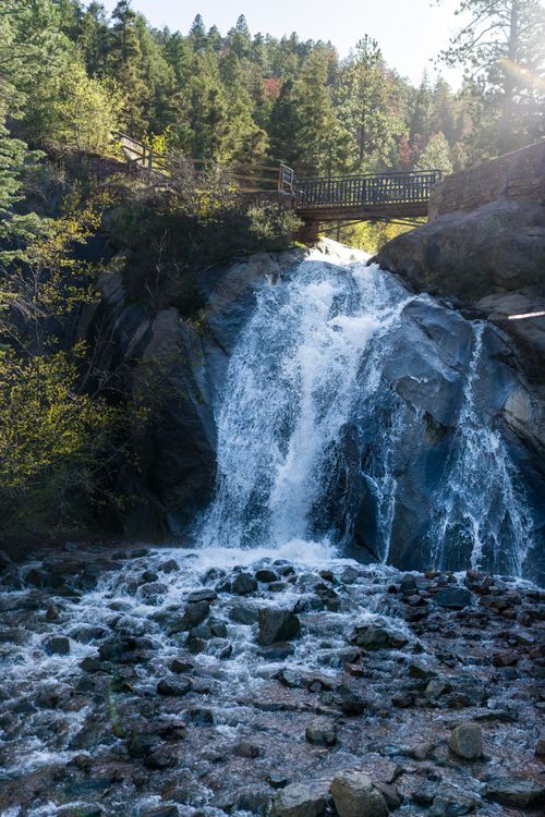 Free Beautiful waterfall at Helen Hunt Falls in Colorado Springs, featuring a scenic footbridge. Stock Photo