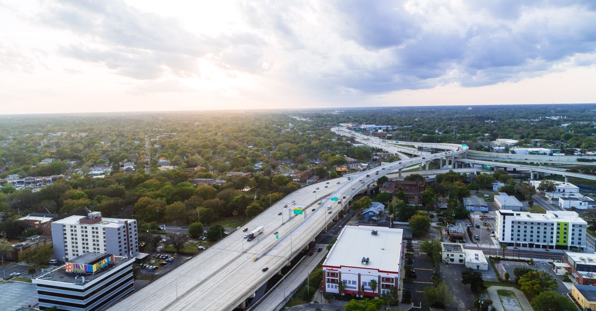 Stunning aerial shot of Jacksonville's highway network with modern buildings at sunset.
