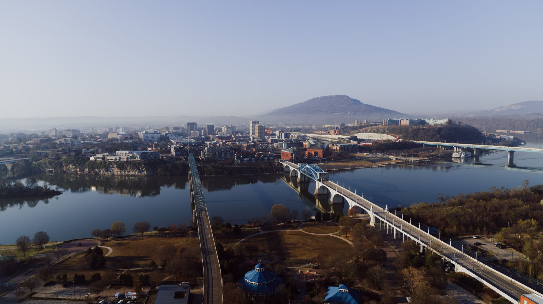 Wide aerial view of downtown Chattanooga, Walnut Street Bridge, Tennessee River, and Lookout Mountain