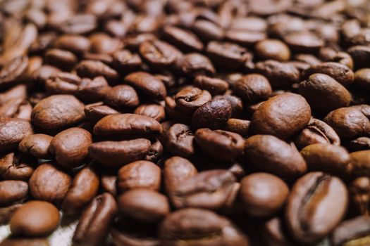 Intense close-up of roasted coffee beans showcasing texture and rich brown tones.