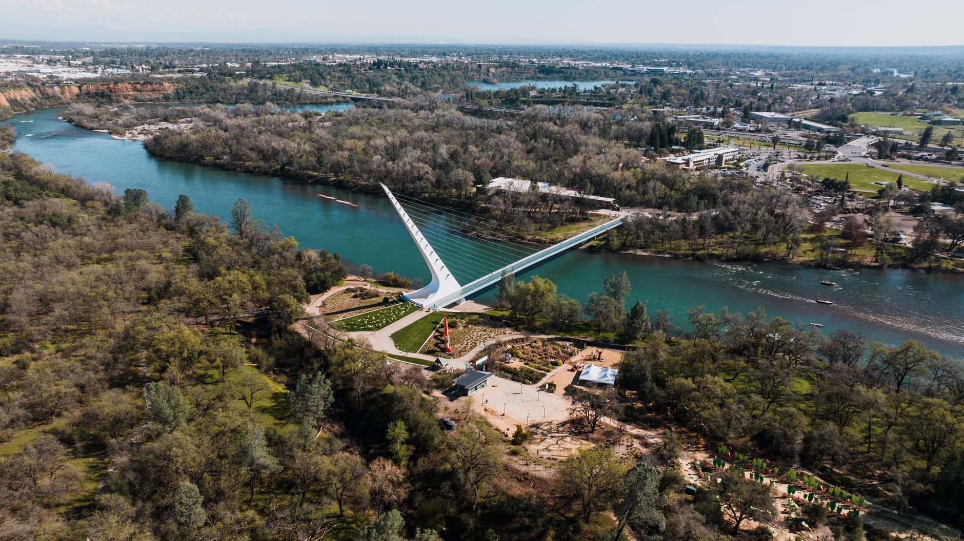 Explore the stunning Sundial Bridge spanning the Sacramento River in Redding, California, from above.