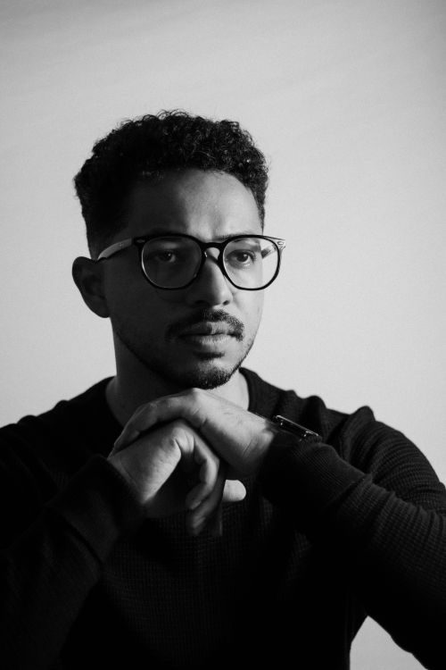 Free Black and white portrait of a man wearing eyeglasses, looking thoughtful. Stock Photo