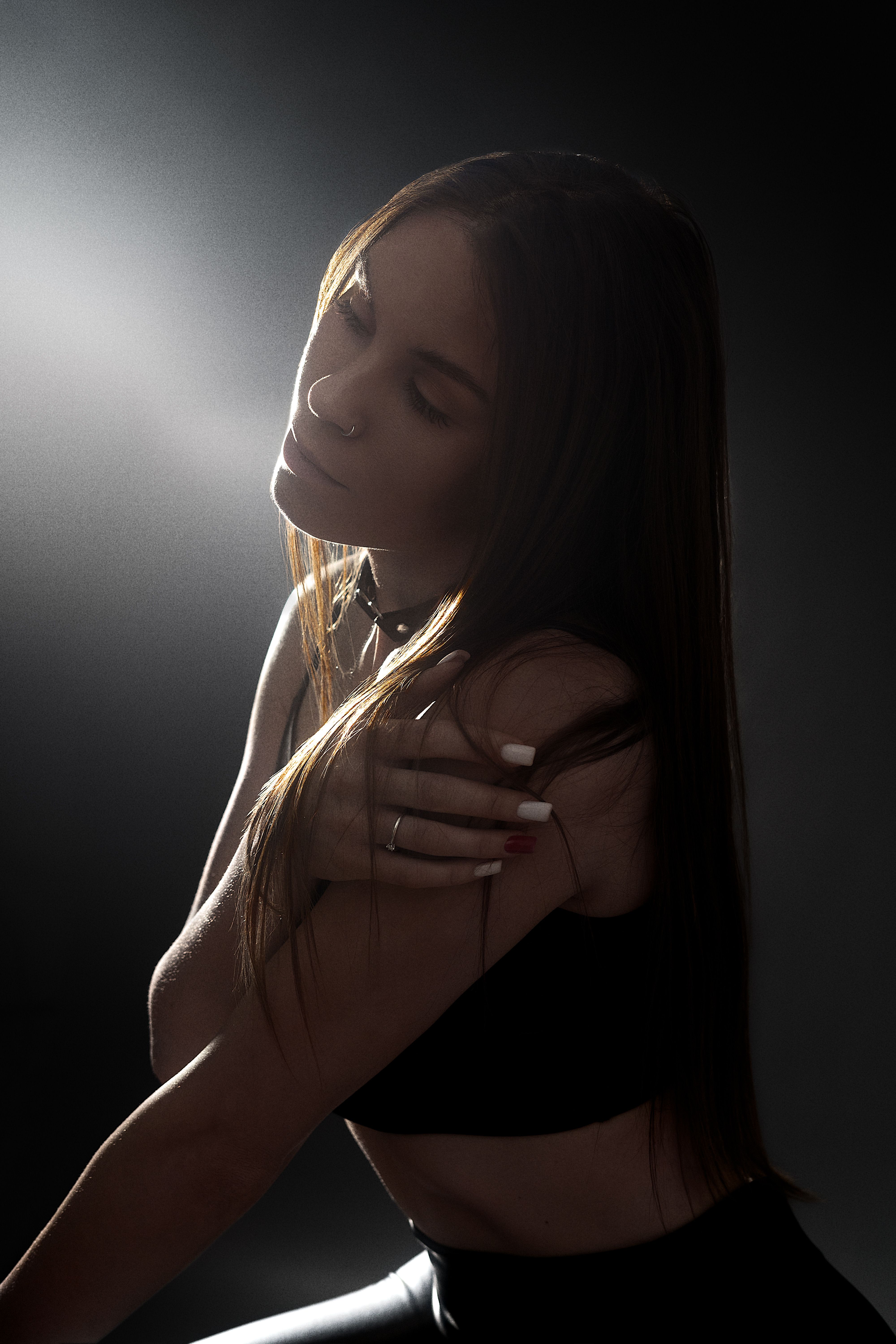 A Woman Sitting in a Dark Room · Free Stock Photo