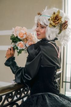 Elegant woman with white wig holding a bouquet in vintage costume, capturing timeless beauty.