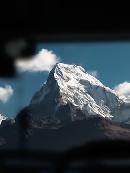 Stunning view of a snow-covered mountain summit with a clear blue sky overhead. 20712193