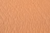 Orange Sand on Desert with Wind Marks