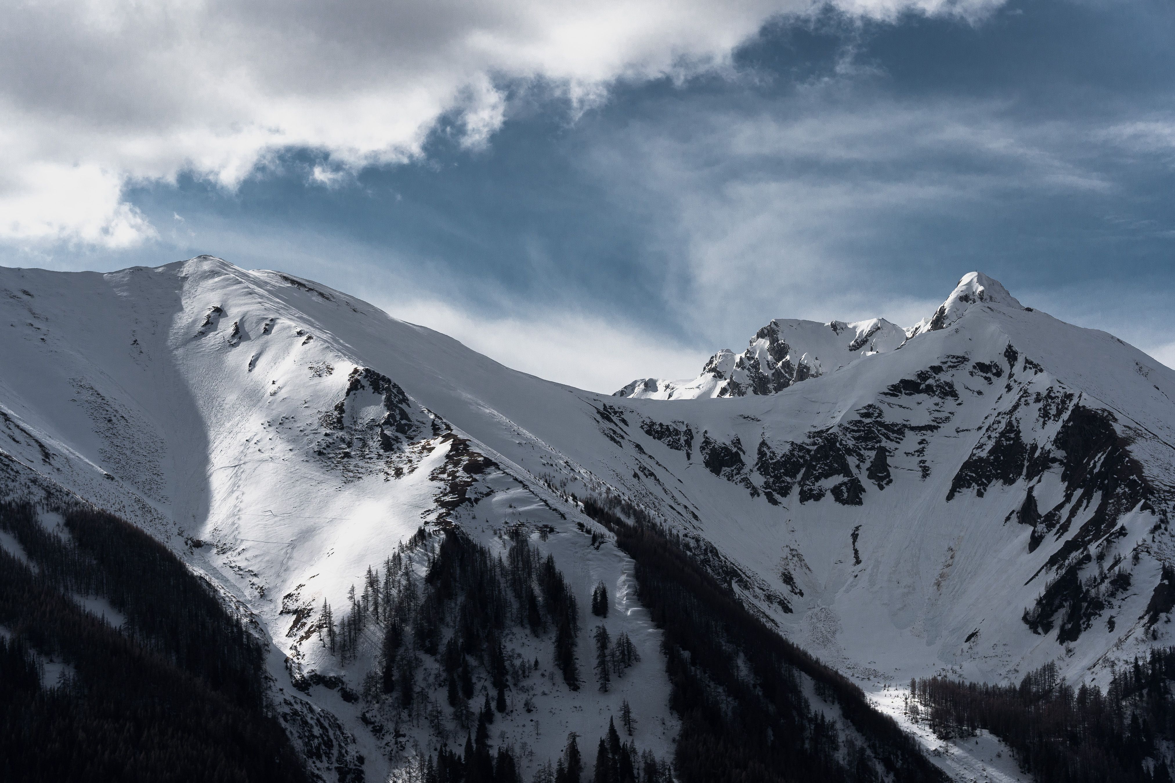 A view of snow covered mountains with clouds · Free Stock Photo