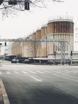 Urban scene featuring industrial silos and city street in Tianjin, China.