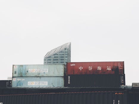 Urban scene of stacked shipping containers with modern architecture background in Tianjin, China.