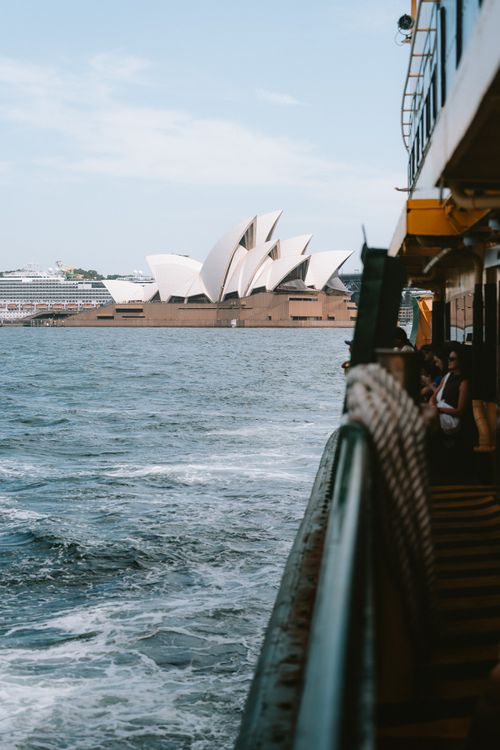 Free View of the iconic Sydney Opera House from a ferry across the sea in Sydney, Australia. Stock Photo