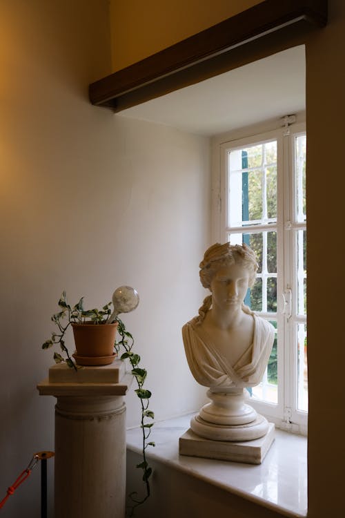 A bust of a woman in a window sill