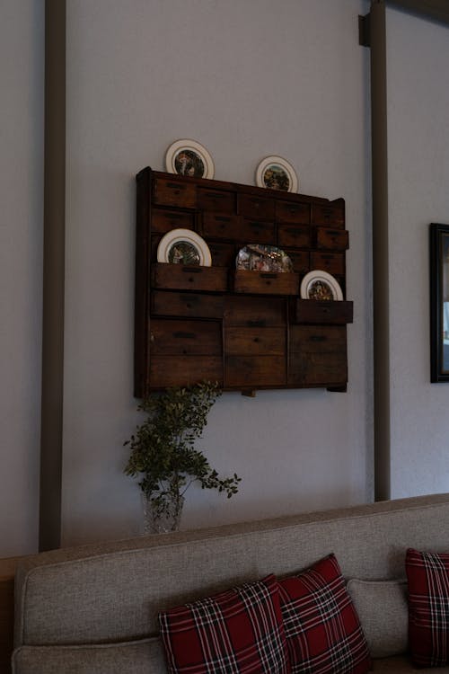 A wall mounted wooden shelf with plates and cups
