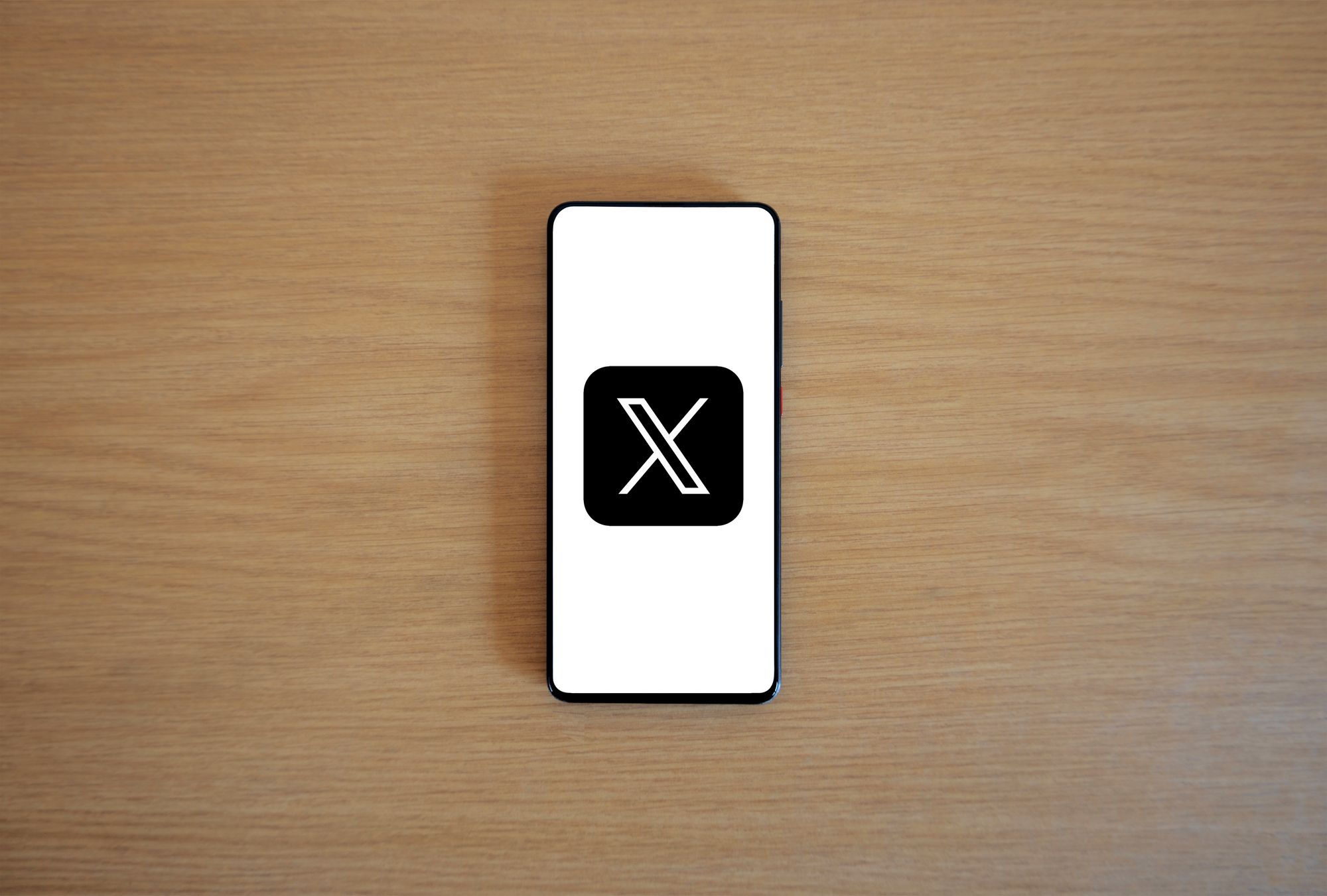 Pantalla de un teléfono móvil con el ícono de la aplicación X entre otras apps