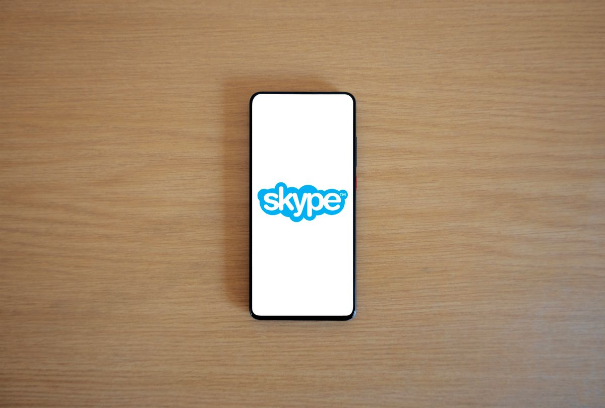 Skype logo on a smartphone on a wooden surface