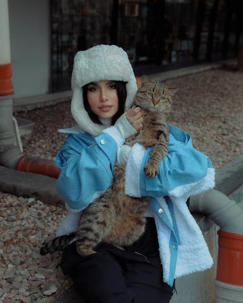 Woman in Fur Hat Holding Cat