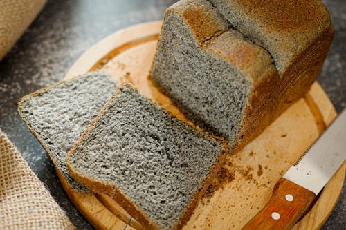 A loaf of bread with a knife next to it