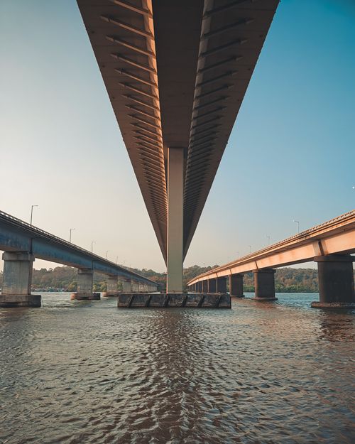 Free A stunning view from beneath a bridge crossing the Mandovi River in Goa, India. Stock Photo