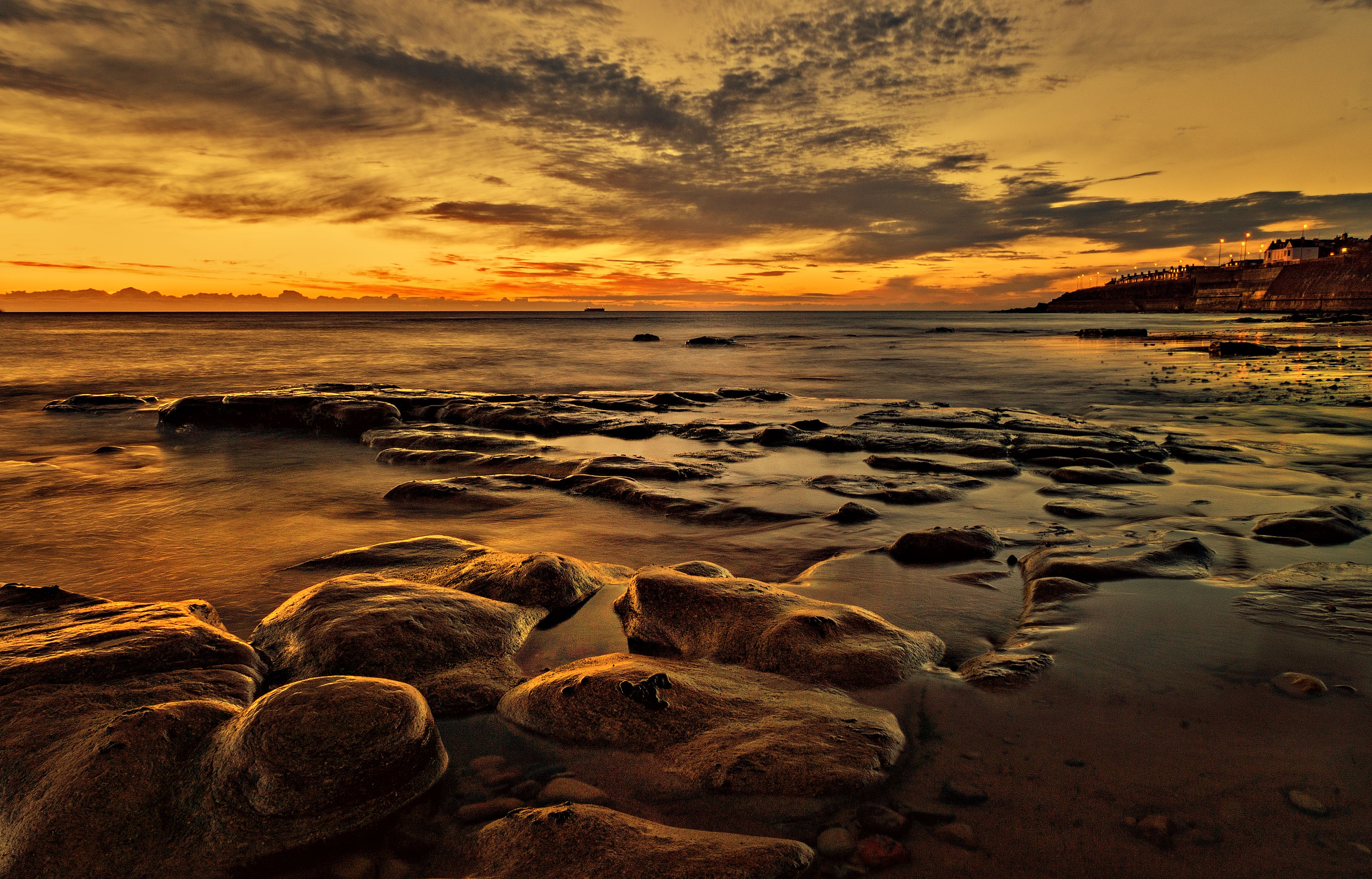 Yellow Sky over Rocks on Sea Shore at Sunset · Free Stock Photo