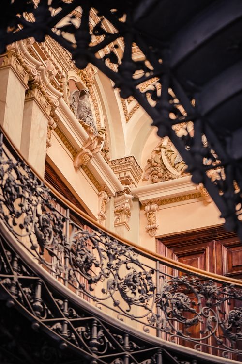 Free A beautifully detailed spiral staircase with elaborate wrought iron railings in a classic interior. Stock Photo