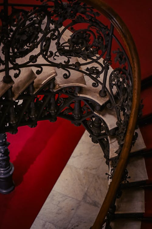 A spiral staircase with ornate ironwork