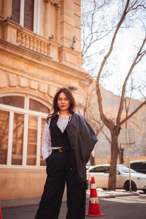 A woman in a suit standing on the street