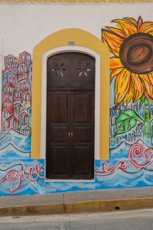 A door is painted on a wall with sunflowers
