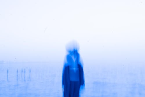 A person standing in the water with a blue background