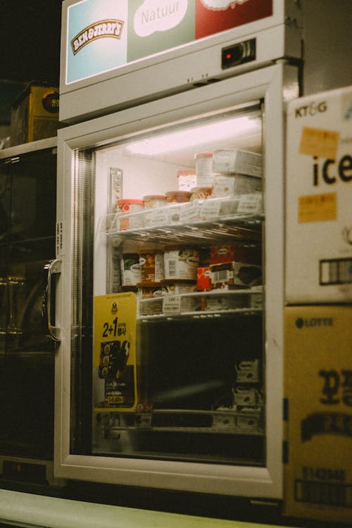A refrigerator with a sign that says, 'open'