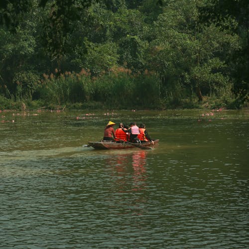A group of people are riding in a boat on a lake