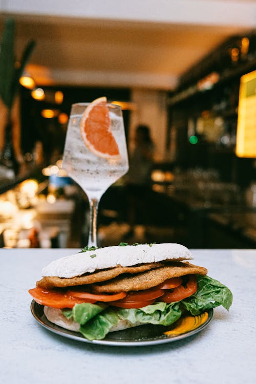Close-up of an Italian Style Sandwich and a Cocktail Served in a Restaurant