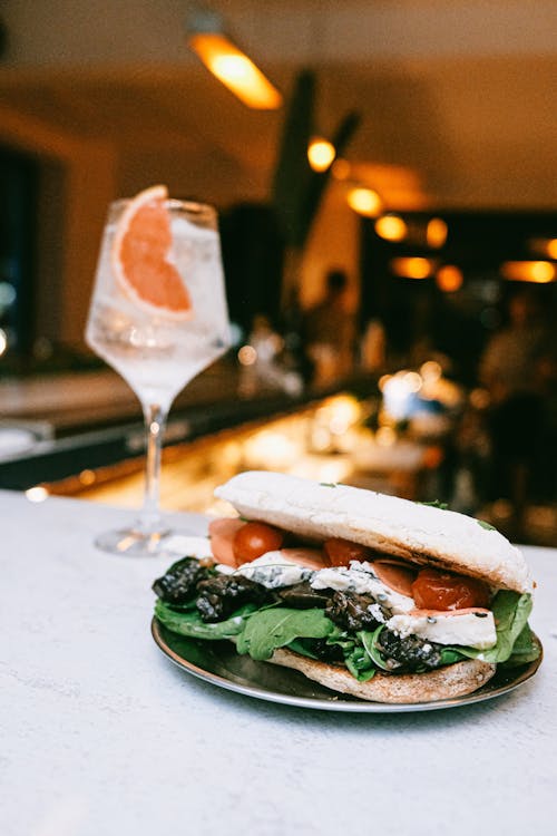 Close-up of an Italian Style Sandwich and a Cocktail Served in a Restaurant