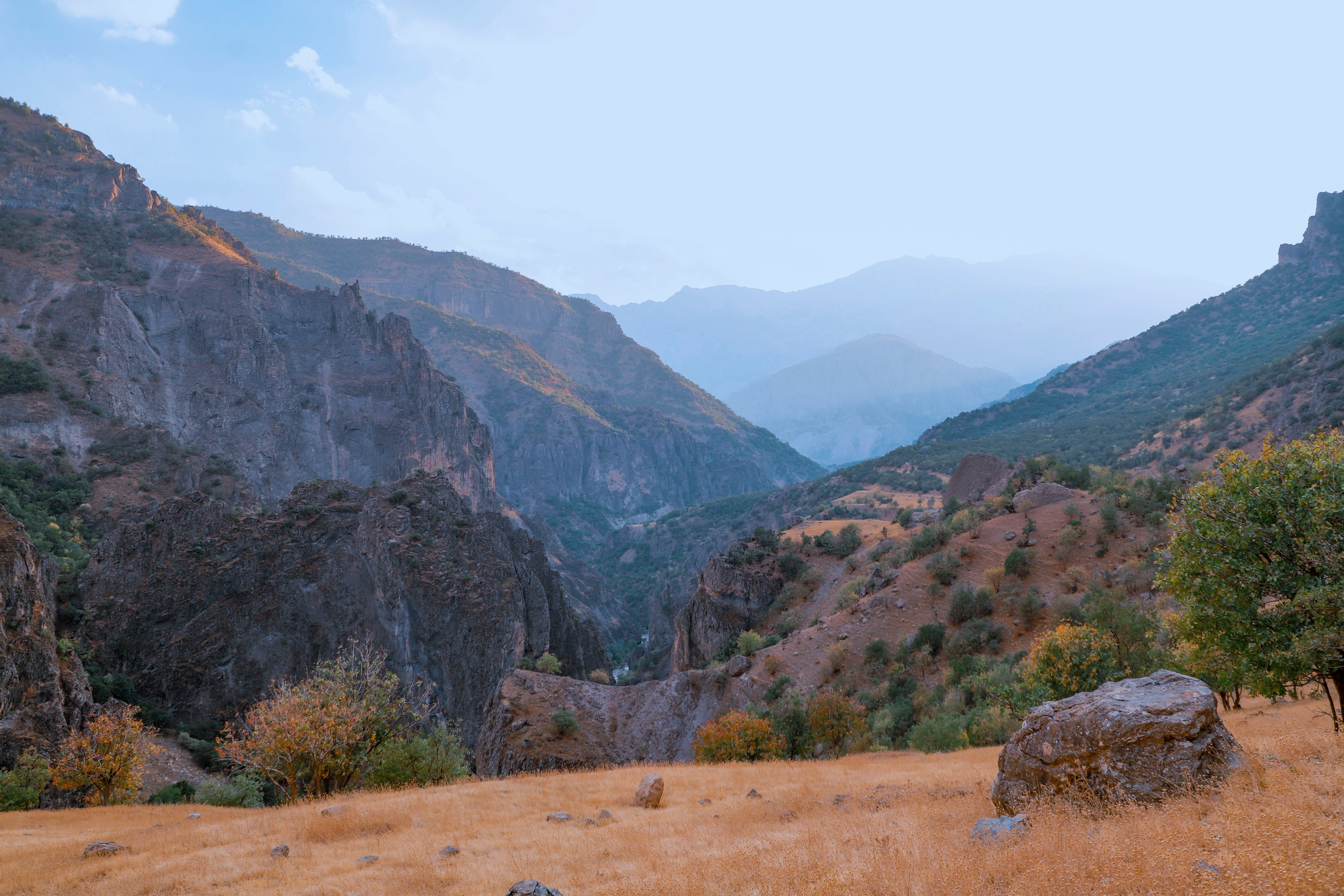 Rock on Dry Land Near Mountains · Free Stock Photo