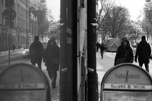 Free Monochrome street view of pedestrians in winter with urban reflections. Stock Photo