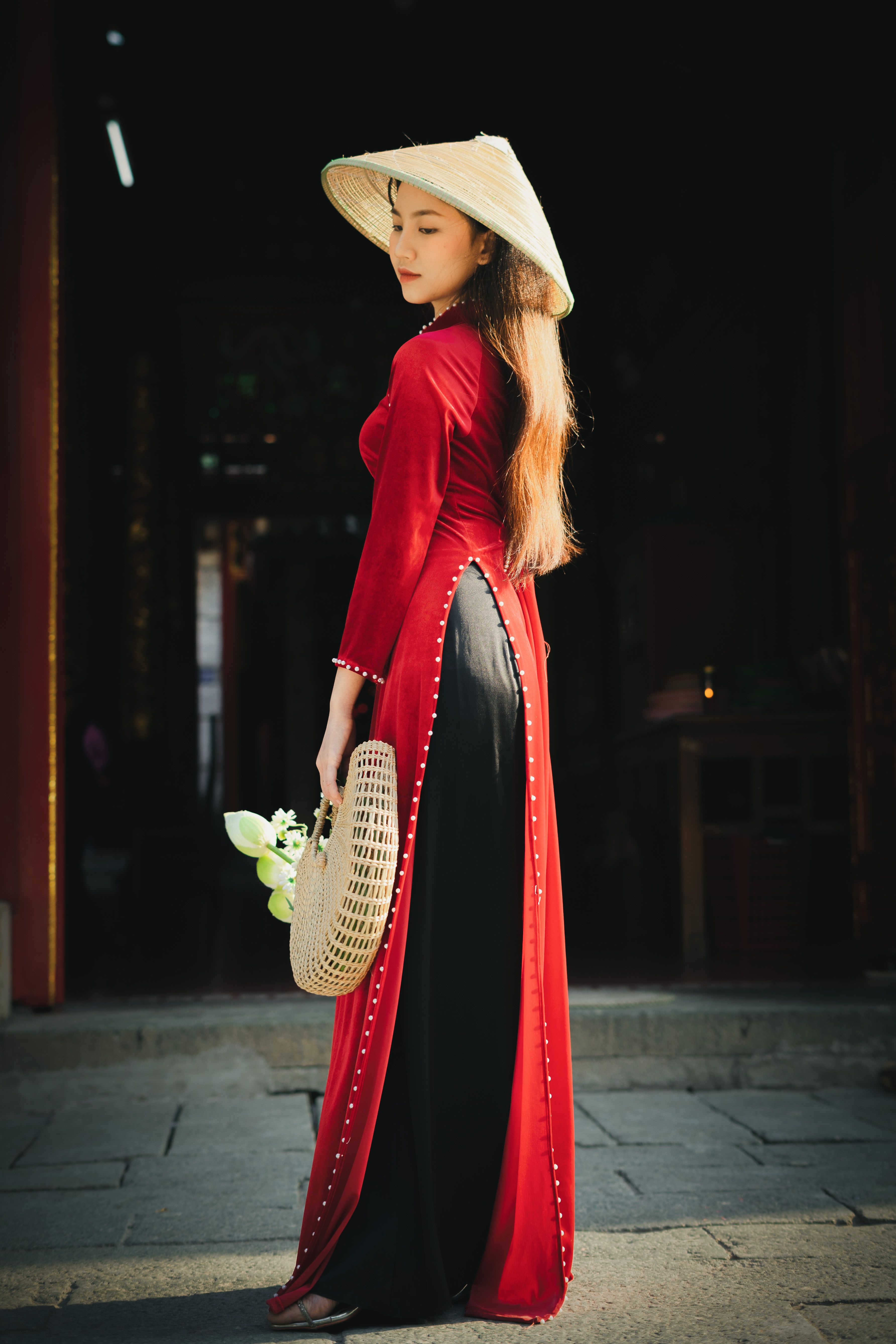 Brunette Woman in Long Red Dress Posing with Hat in Hand  Free Stock Photo